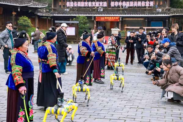 Robot dogs dance their way into the hearts of visitors at Xijiang Qianhu Miao Village in SW China's Guizhou